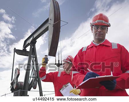 Stock Photography - Workers with crude oil and oil well. Fotosearch