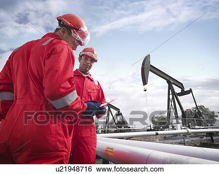 Workers with oil wells View Large Photo Image Stock Photograph - Workers with oil wells. Fotosearch