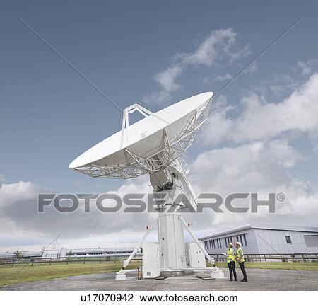 Stock Image - Workers with satellite dish. Fotosearch