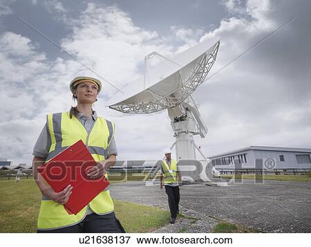 Workers with satellite dish View Large Photo Image Stock Photo - Workers with satellite dish. Fotosearch