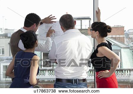 Workmates looking at plans View Large Photo Image Stock Photo - Workmates looking at plans. Fotosearch