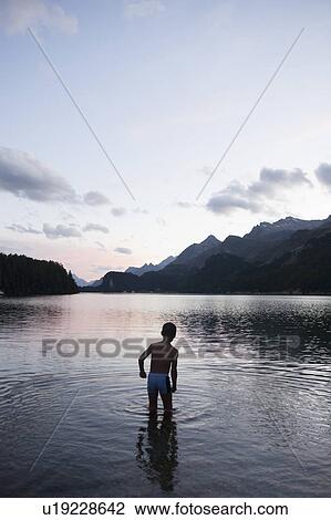 Young boy bathing in lake at night View Large Photo Image Stock Image - Young boy bathing in lake at night. Fotosearch