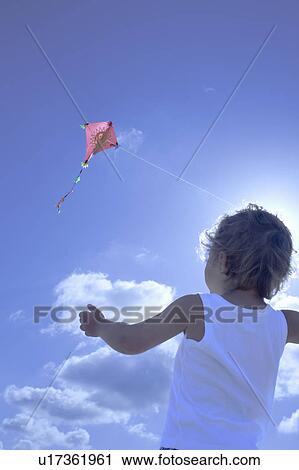 Young boy flying a kite View Large Photo Image Stock Image - Young boy flying a kite. Fotosearch