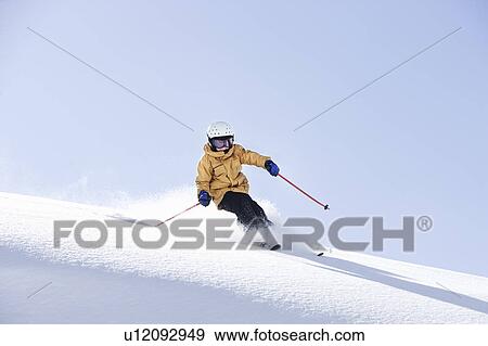 Young boy skiing through fresh powder View Large Photo Image Stock Photo - Young boy skiing through fresh powder. Fotosearch