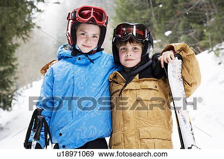 Young children hugging in snow with skis View Large Photo Image Stock Photo - Young children hugging in snow with skis. Fotosearch