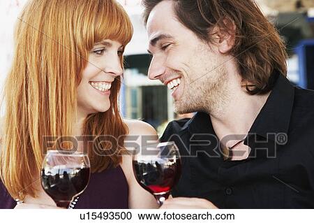 Young couple clinking glasses View Large Photo Image Stock Image - Young couple clinking glasses. Fotosearch
