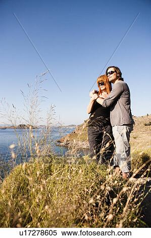 Young couple enjoying view View Large Photo Image Stock Photography - Young couple enjoying view. Fotosearch