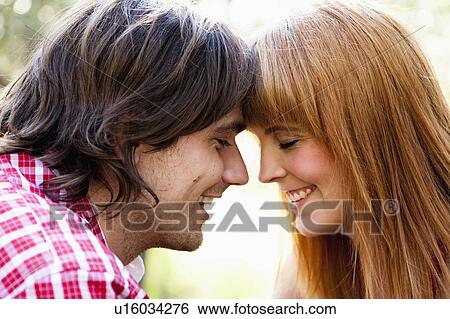 Young couple facing View Large Photo Image Stock Photograph - Young couple facing. Fotosearch