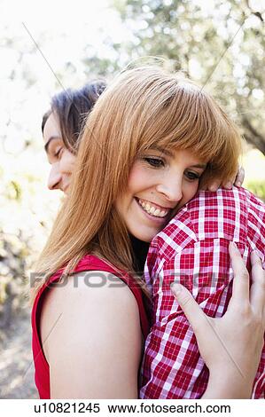Stock Photography - Young couple hugging. Fotosearch