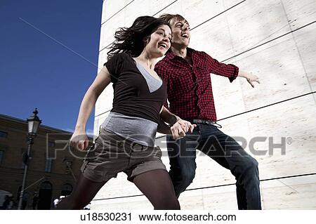 Young couple jumping down the stairs View Large Photo Image Stock Image - Young couple jumping down the stairs. Fotosearch