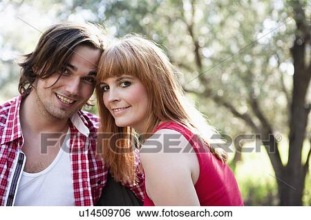 Young couple leaning heads together View Large Photo Image Stock Photograph - Young couple leaning heads together. Fotosearch