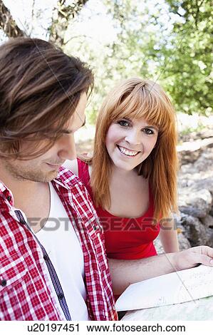 Young couple looking at map View Large Photo Image Stock Image - Young couple looking at map. Fotosearch