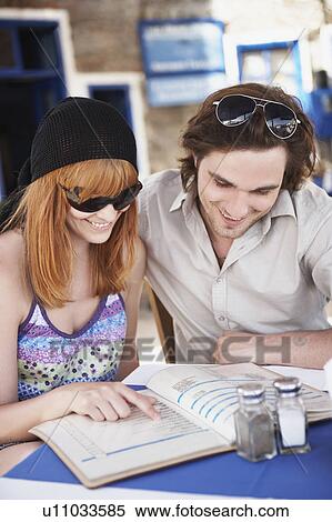 Young couple looking at menu View Large Photo Image Stock Photography - Young couple looking at menu. Fotosearch