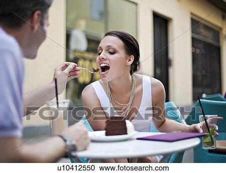 Young couple sitting in outdoor cafÈ View Large Photo Image Stock Image - Young couple sitting in outdoor cafÈ. Fotosearch