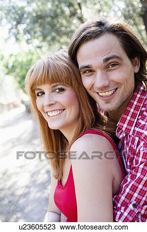 Young couple smiling to camera View Large Photo Image Stock Image - Young couple smiling to camera. Fotosearch