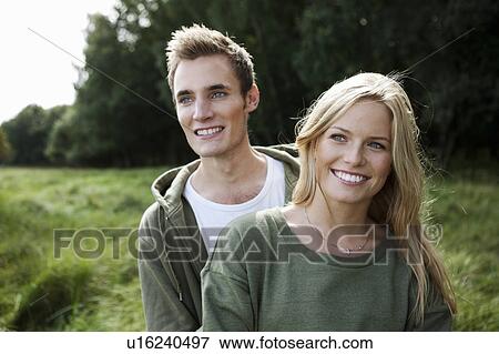 Stock Photo - Young couple standing in nature. Fotosearch