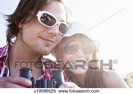 Young couple with binoculars View Large Photo Image Stock Photography - Young couple with binoculars. Fotosearch