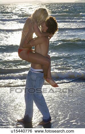 Young cple kiss at sunset beach View Large Photo Image Stock Photograph - Young cple kiss at sunset beach. Fotosearch