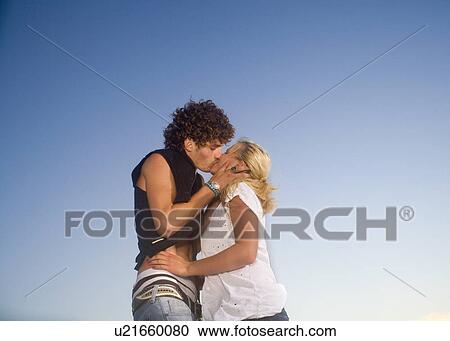 Young cple kiss outide View Large Photo Image Stock Image - Young cple kiss outide. Fotosearch