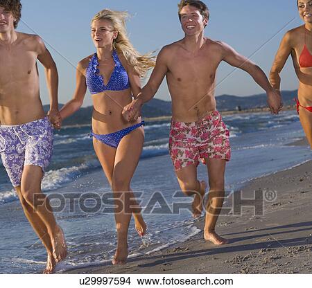 Young energy group run at beach View Large Photo Image Picture - Young energy group run at beach. Fotosearch