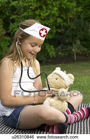 Stock Photograph - Young girl and teddy bear. Fotosearch