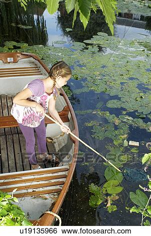 Stock Photograph - Young girl fishing with net. Fotosearch