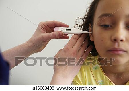 Young girl having temperature taken View Large Photo Image Stock Photo - Young girl having temperature taken. Fotosearch