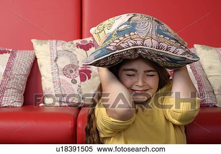 Young girl hiding under cushion View Large Photo Image Stock Photography - Young girl hiding under cushion. Fotosearch
