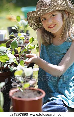 Young Girl looking at vegetable plants View Large Photo Image Stock Image - Young Girl looking at vegetable plants. Fotosearch