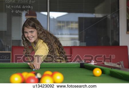 Young girl playing pool View Large Photo Image Stock Image - Young girl playing pool. Fotosearch