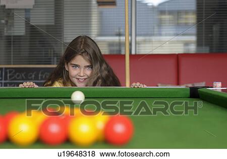 Stock Photo - Young girl playing pool. Fotosearch