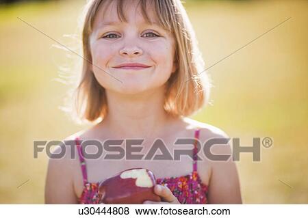 Young girl with apple smiling View Large Photo Image Stock Photo - Young girl with apple smiling. Fotosearch