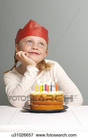 Young girl with cake, daydreaming View Large Photo Image Stock Photo - Young girl with cake, daydreaming. Fotosearch