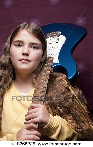 Young girl with guitar on shoulder View Large Photo Image Stock Photography - Young girl with guitar on shoulder. Fotosearch