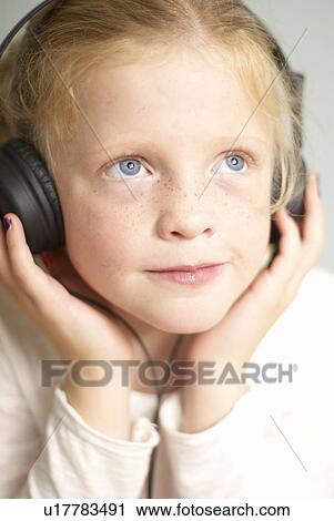 Young girl with headphones on View Large Photo Image Stock Image - Young girl with headphones on. Fotosearch