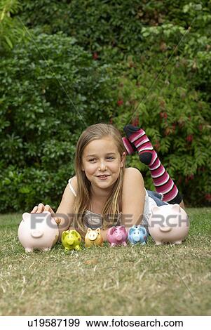 Young girl with lots of piggy banks View Large Photo Image Stock Photo - Young girl with lots of piggy banks. Fotosearch