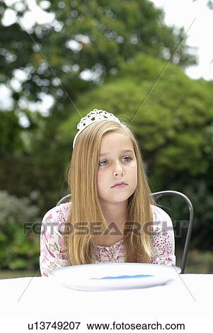 Stock Photo - Young girl with tiara on, daydreaming. Fotosearch