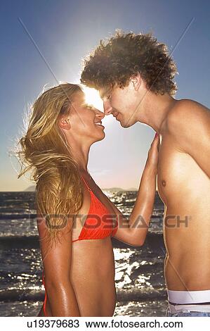 Young loving cple at beach View Large Photo Image Stock Image - Young loving cple at beach. Fotosearch