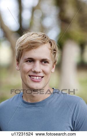 Young man in nature View Large Photo Image Picture - Young man in nature. Fotosearch