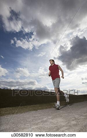 Stock Image - Young man jogging. Fotosearch