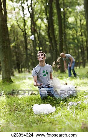 Young man juggling with paper trash View Large Photo Image Picture - Young man juggling with paper trash. Fotosearch
