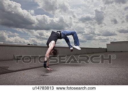 Young man jumping backwards View Large Photo Image Stock Image - Young man jumping backwards. Fotosearch