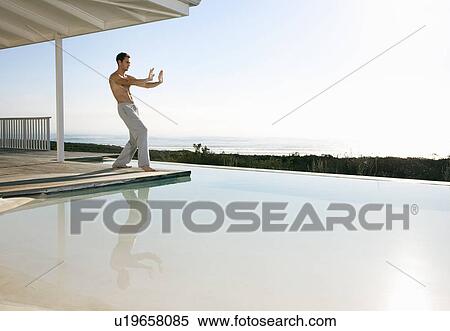 Young man practicing tai chi View Large Photo Image Stock Photography - Young man practicing tai chi. Fotosearch