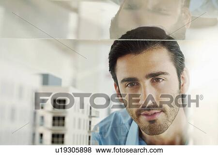 Young man with architectural model View Large Photo Image Stock Photo - Young man with architectural model. Fotosearch