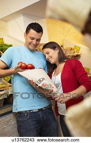 Young people buying fruits and vegetable View Large Photo Image Stock Image - Young people buying fruits and vegetable. Fotosearch