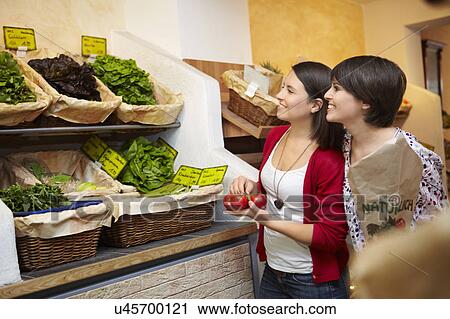 Young people buying fruits and vegetable View Large Photo Image Stock Image - Young people buying fruits and vegetable. Fotosearch
