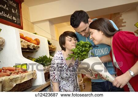 Young people buying fruits and vegetable View Large Photo Image Stock Photo - Young people buying fruits and vegetable. Fotosearch