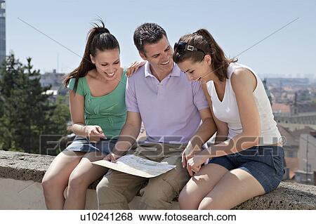 Young people looking at map View Large Photo Image Stock Photo - Young people looking at map. Fotosearch