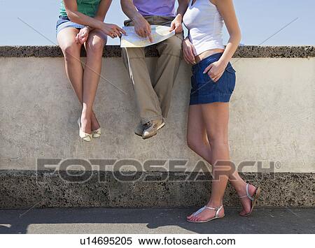 Young people looking at map View Large Photo Image Stock Photography - Young people looking at map. Fotosearch