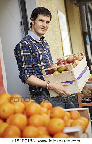 Young person in a fruit stall View Large Photo Image Stock Image - Young person in a fruit stall. Fotosearch
